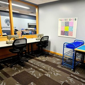 Photo of the Fabric Arts room in the Makerspace showing 2 heavy duty Singer sewing machines